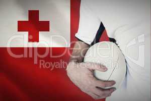 Composite image of midsection of rugby player holding ball