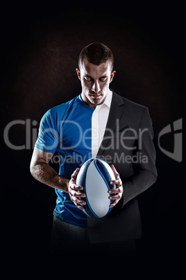 Composite image of rugby player holding ball