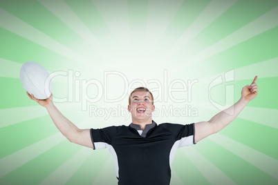 Composite image of a rugby player gesturing victory