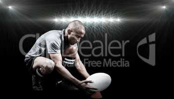 Composite image of rugby player keeping ball on kicking tee