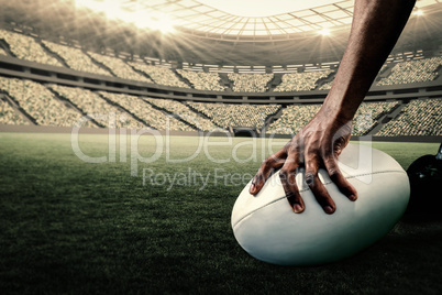 Composite image of cropped image of athlete holding rugby ball