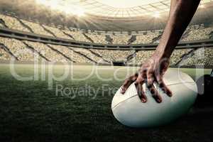 Composite image of cropped image of athlete holding rugby ball