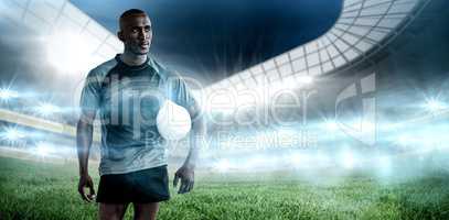 Composite image of sportsman with rugby ball