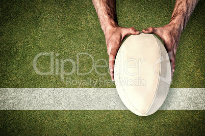 Composite image of man holding rugby ball