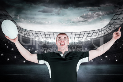 Composite image of a rugby player gesturing victory