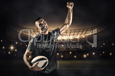 Composite image of happy rugby player punching the air