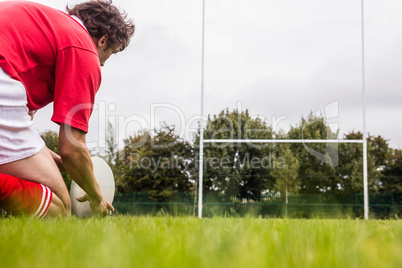 Rugby player getting ready to kick ball