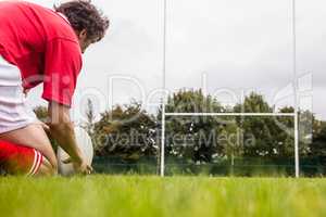 Rugby player getting ready to kick ball