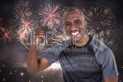 Composite image of portrait of sportsman cheering after success