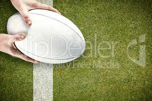 Composite image of rugby player catching a rugby ball