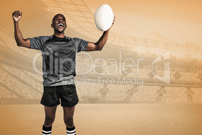 Composite image of cheerful sportsman with clenched fist holding