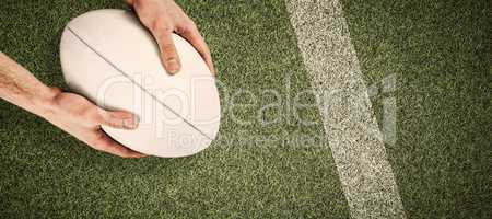 Composite image of rugby player catching a rugby ball