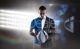 Composite image of rugby player holding ball