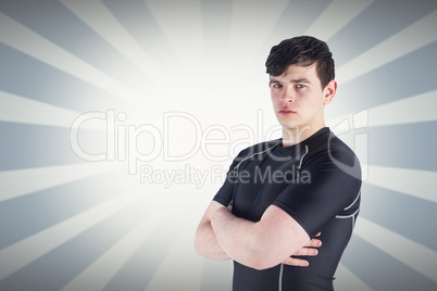 Composite image of portrait of a rugby player with arms crossed