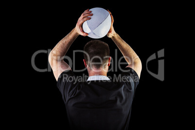 Composite image of rugby player about to throw a rugby ball