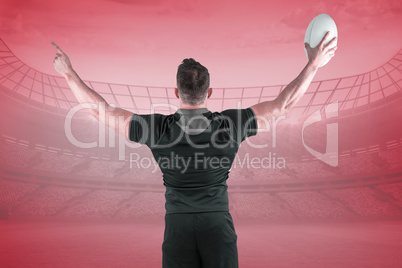 Composite image of rugby player celebrating with the ball