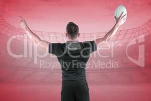 Composite image of rugby player celebrating with the ball