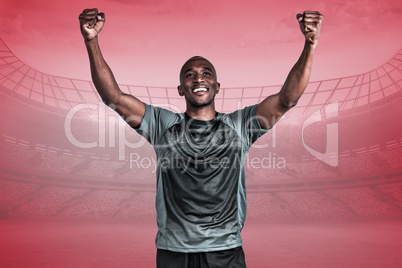 Composite image of happy sportsman with clenched fist after vict