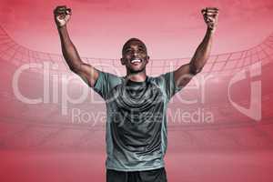 Composite image of happy sportsman with clenched fist after vict