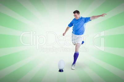 Composite image of rugby player doing a drop kick