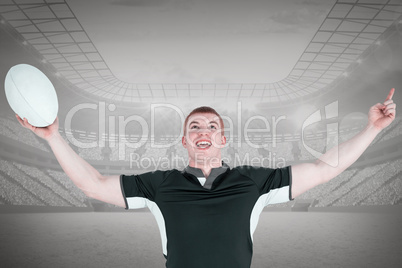 Composite image of a rugby player gesturing victory