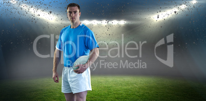 Composite image of rugby player holding a rugby ball