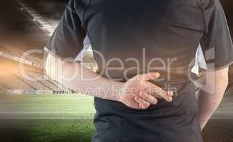 Composite image of back turned rugby player with fingers crossed