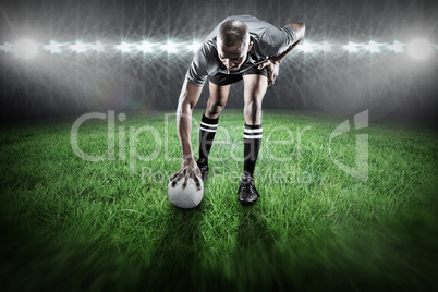 Composite image of rugby player taking position Composite image of rugby player taking position