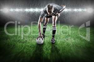 Composite image of rugby player taking position