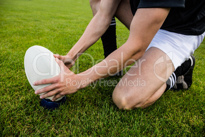 Rugby player picking up ball
