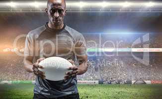 Composite image of portrait of serious sportsman holding rugby b
