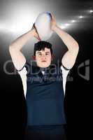 Composite image of portrait of a rugby player throwing a ball
