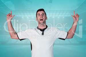 Composite image of surprised rugby player pointing up