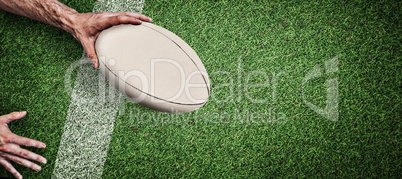 Composite image of cropped image of a man holding rugby ball