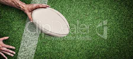 Composite image of cropped image of a man holding rugby ball