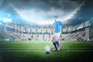 Composite image of rugby player doing a drop kick