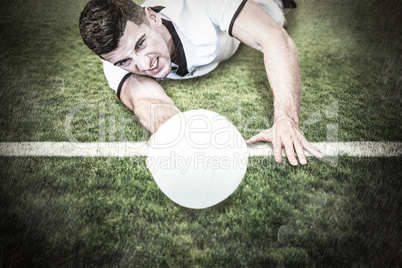 Composite image of man lying down while holding ball