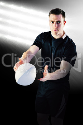 Composite image of rugby player about to throw a rugby ball