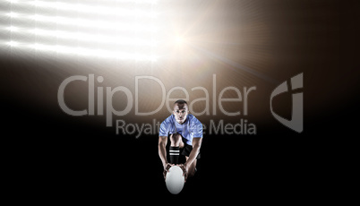 Composite image of portrait of rugby player kneeling and holding