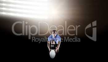 Composite image of portrait of rugby player kneeling and holding