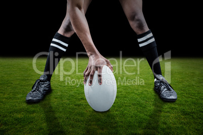 Composite image of low section of sportsman playing rugby