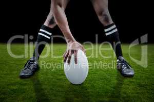 Composite image of low section of sportsman playing rugby