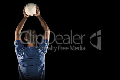 Composite image of rear view of sports player throwing ball