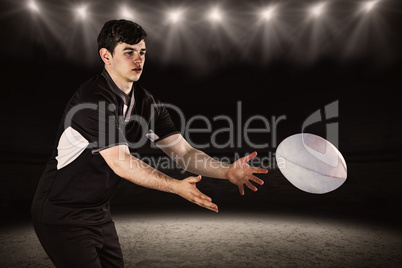 Composite image of rugby player throwing a rugby ball