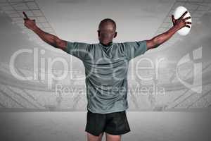 Composite image of rear view of athlete with arms raised holding