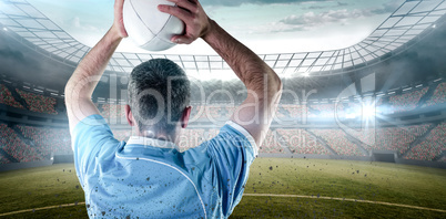 Composite image of rugby player about to throw a rugby ball