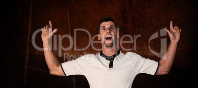 Composite image of surprised rugby player pointing up