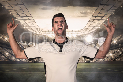 Composite image of excited rugby player pointing up