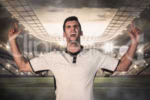 Composite image of excited rugby player pointing up