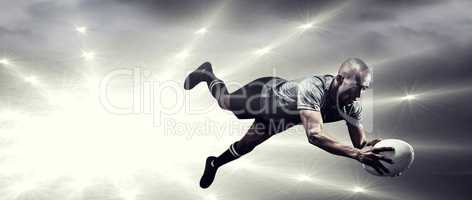 Composite image of sportsman jumping for catching rugby ball